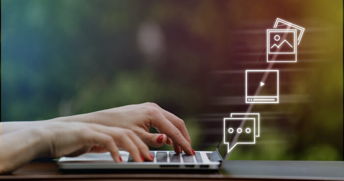 Image shows hands on a computer keyboard. The article is about social media influencers.