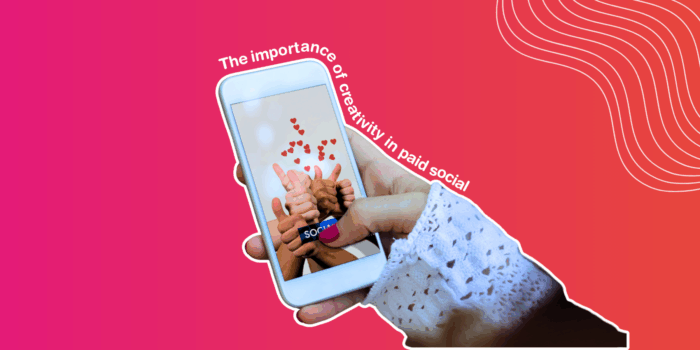 Hand holding a phone with a social image on
